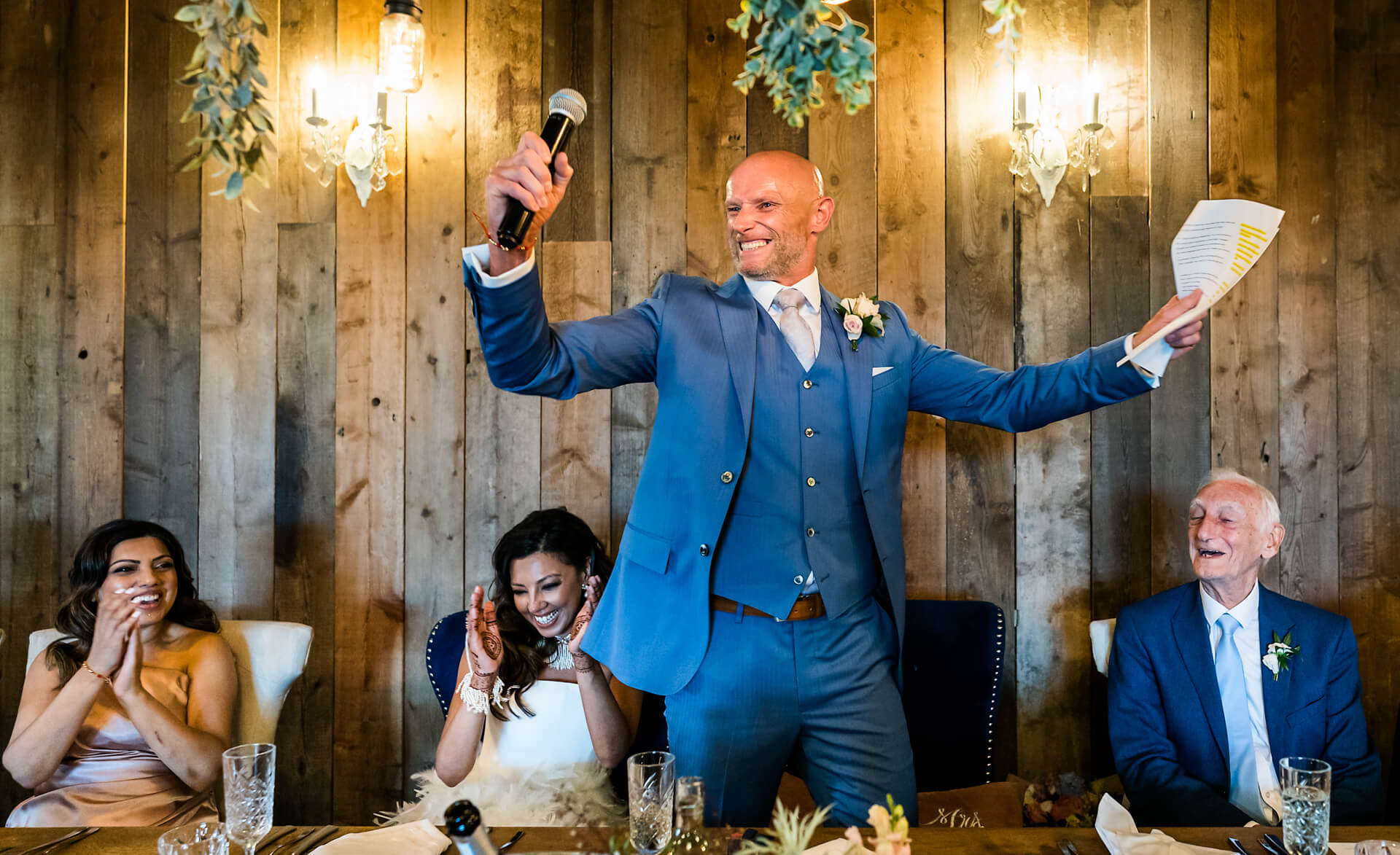 Groom giving toast at wedding reception.