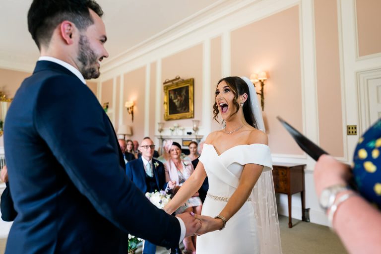 Bride's joyful reaction during wedding vow exchange at Bowcliffe Hall