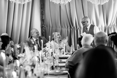 Joyful wedding reception speech in monochrome