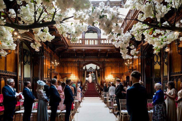 Elegant wedding ceremony in ornate Gothic-style hall at Allerton Castle