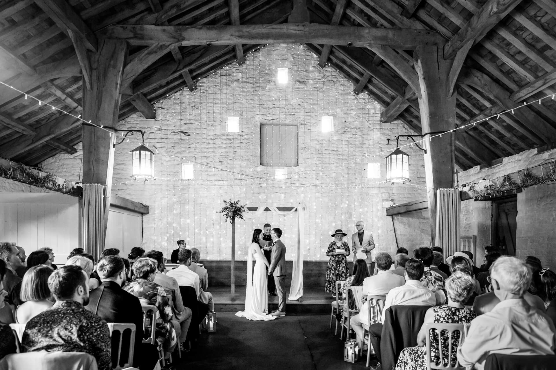 Wedding ceremony in rustic wedding barn at East Riddlesden Hall