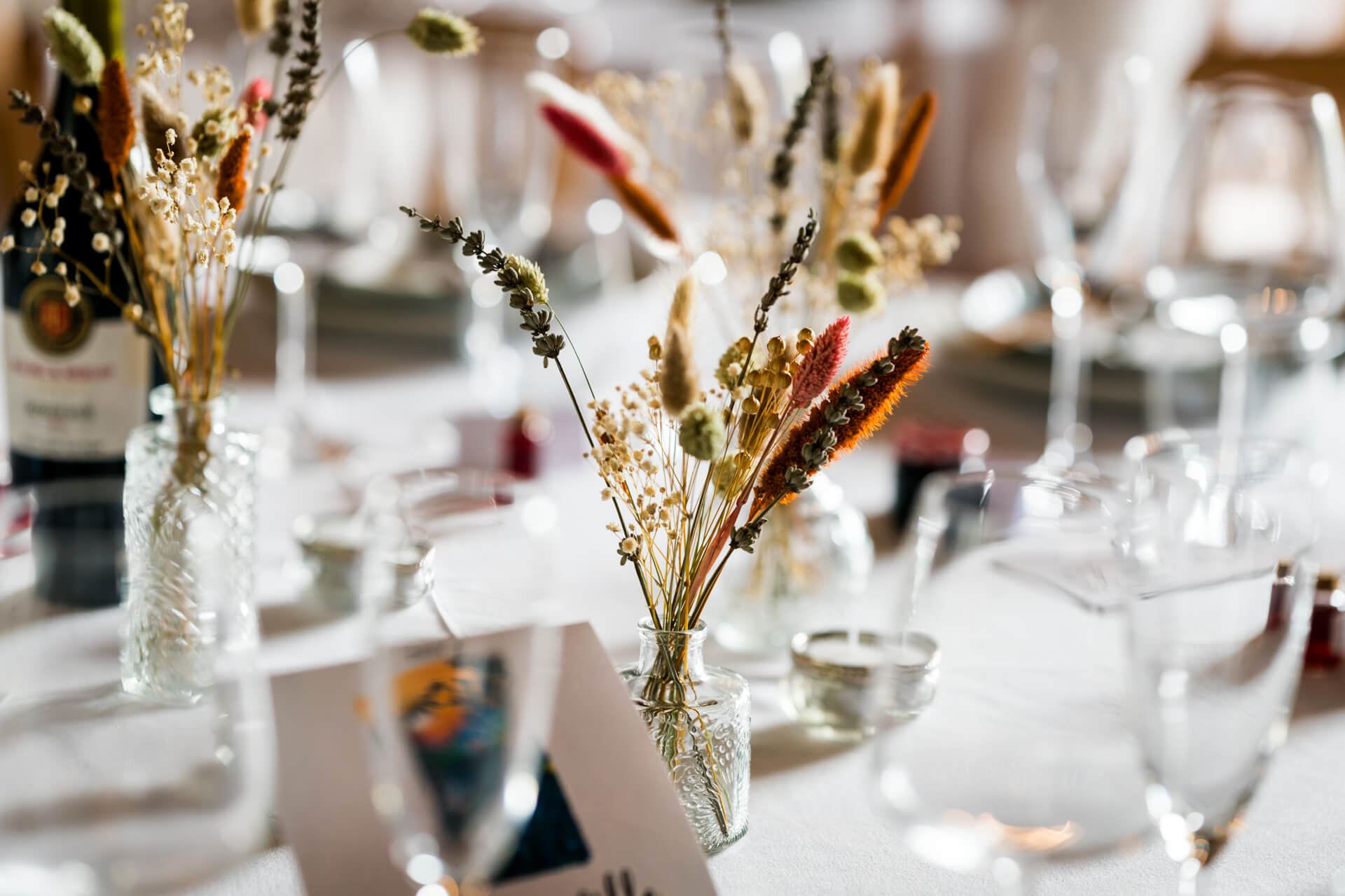 Elegant table setting with assorted dried floral arrangements
