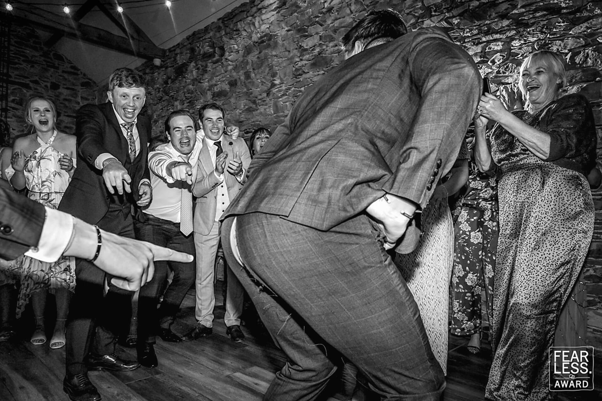 Guests laughing at humourous wedding incident