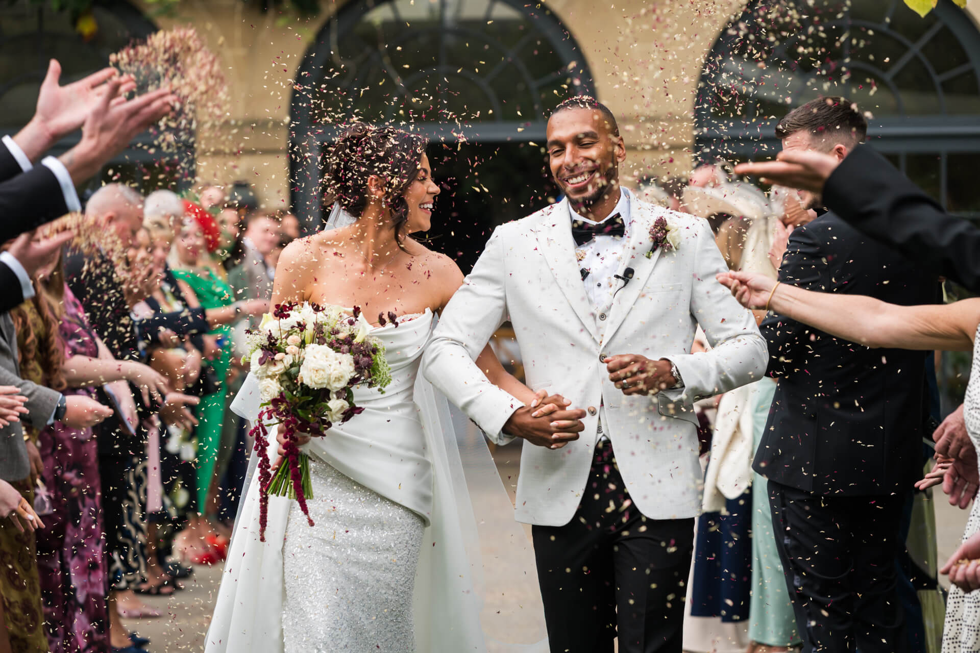 Newlyweds celebrate with confetti after wedding ceremony.