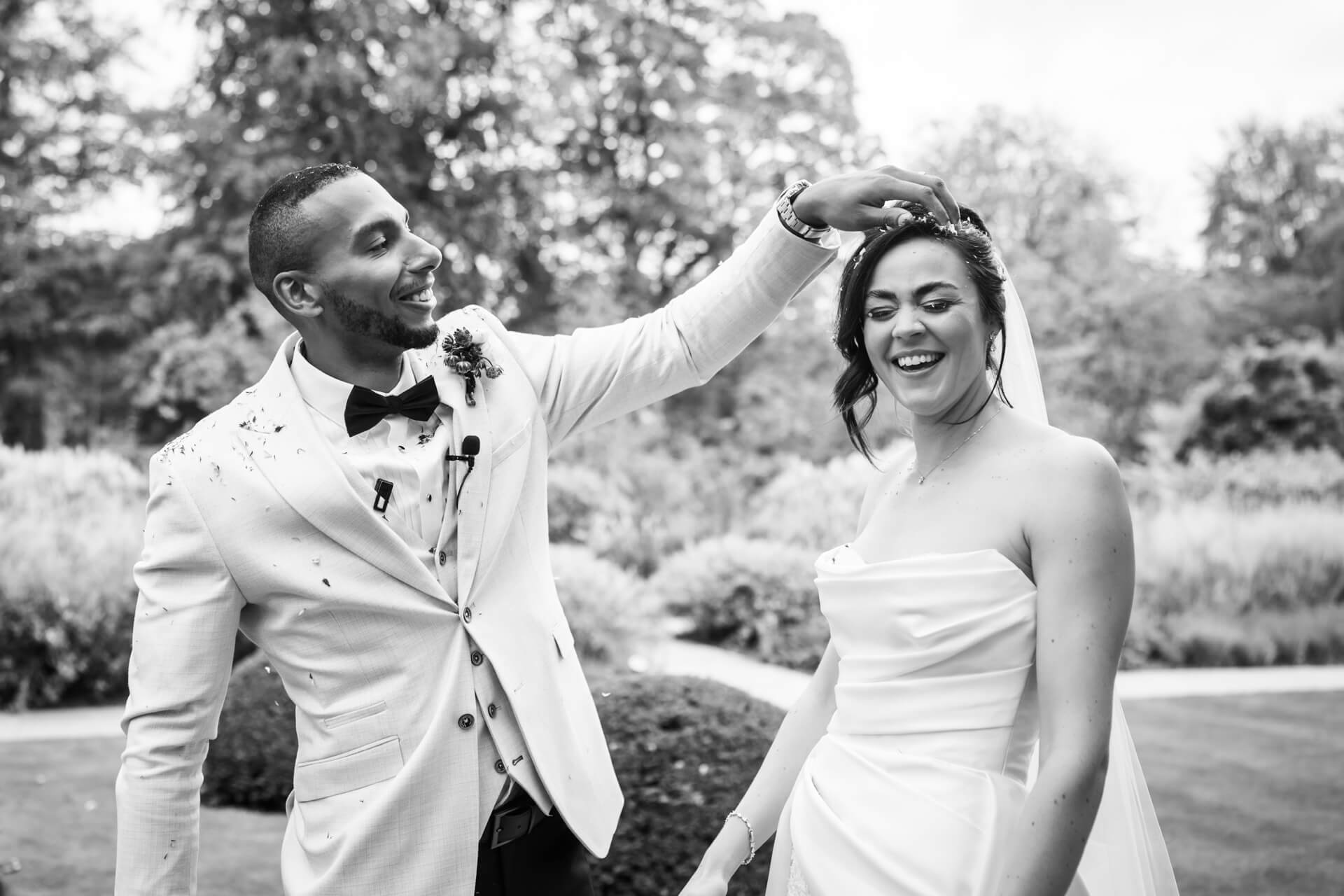 Smiling couple at outdoor wedding celebration.