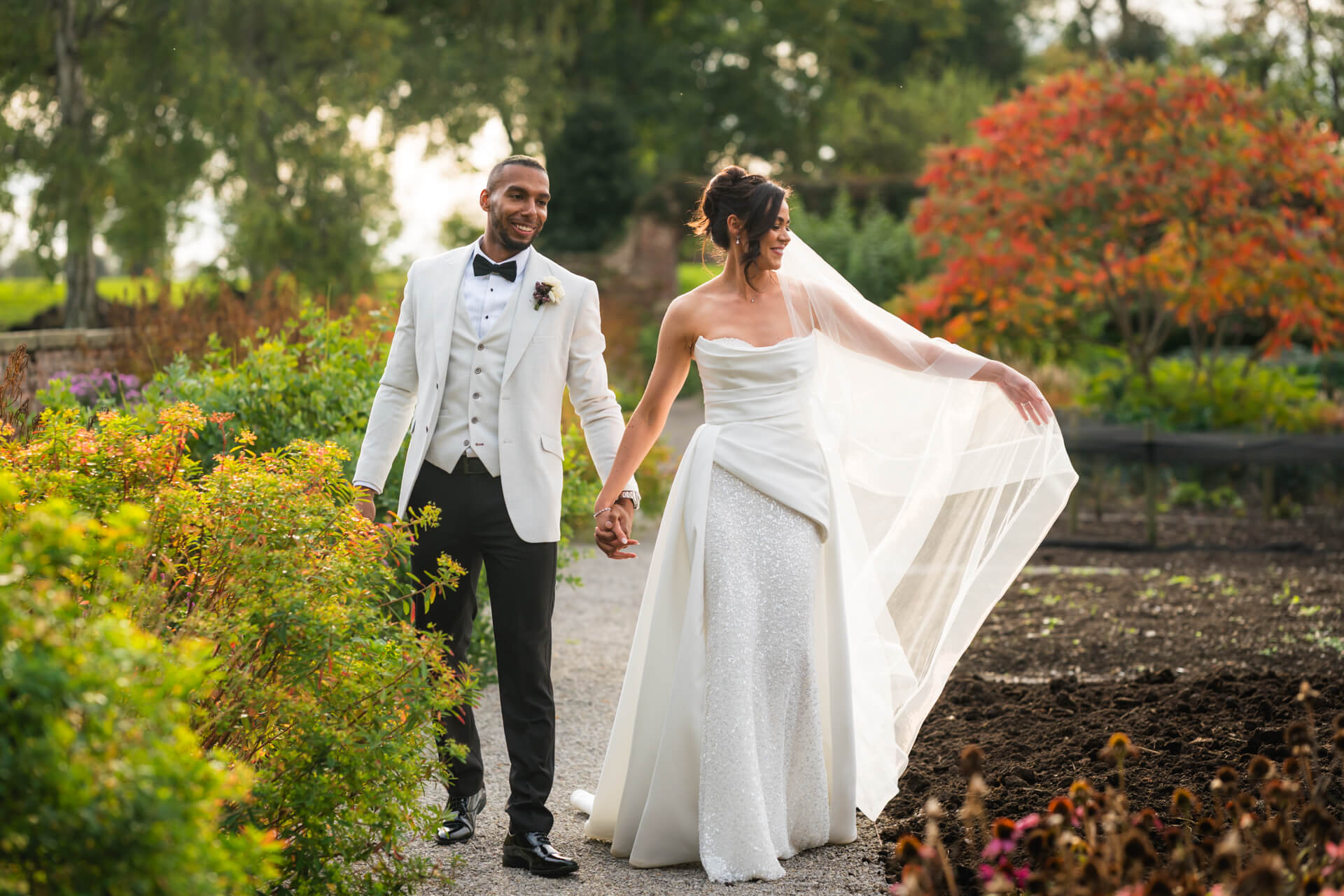 Bride and groom walking in a garden