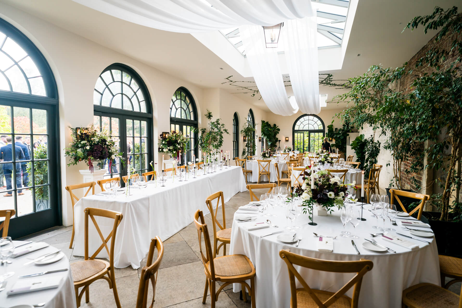 Elegant wedding reception with floral centrepieces.