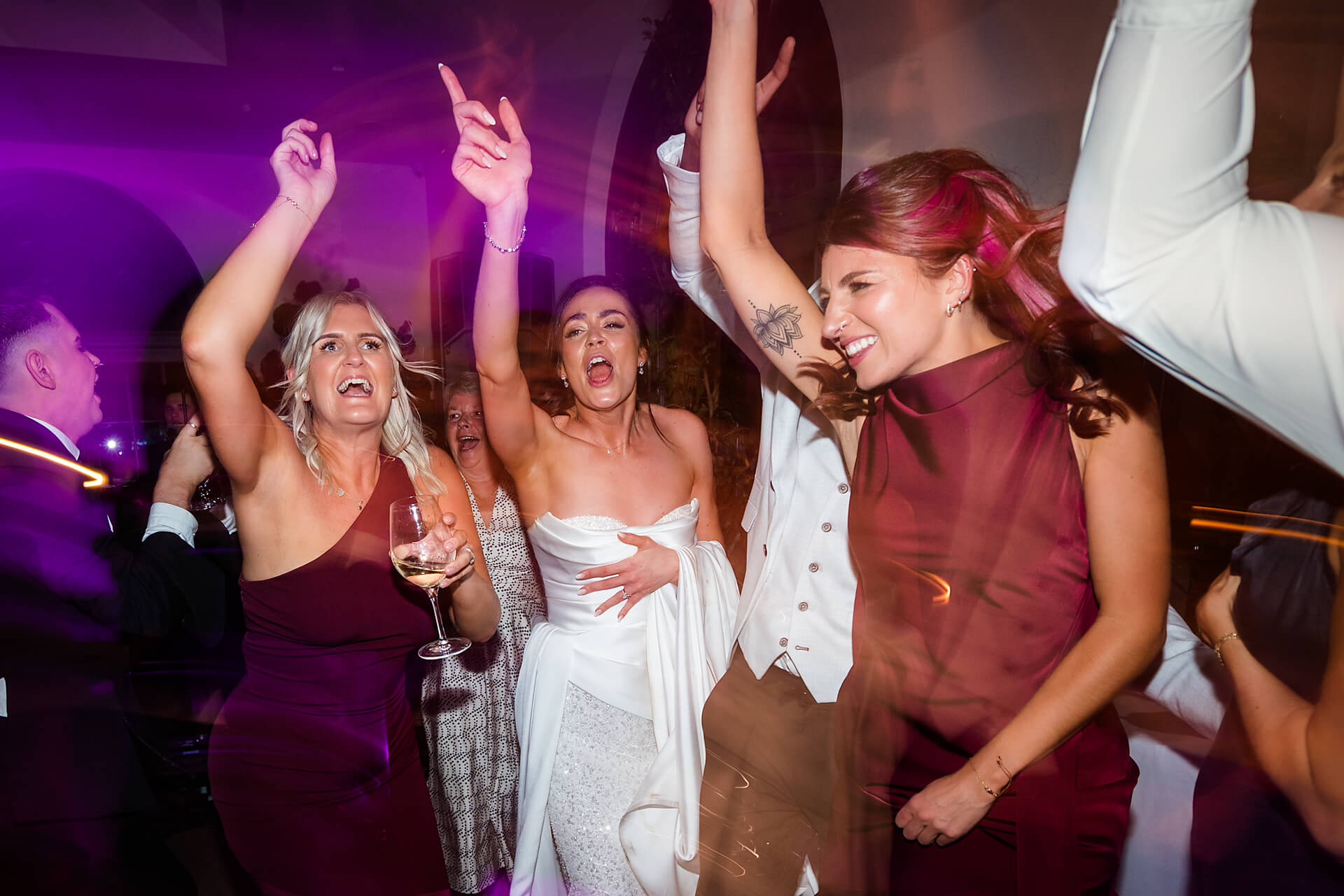 Women dancing joyfully at a lively party.