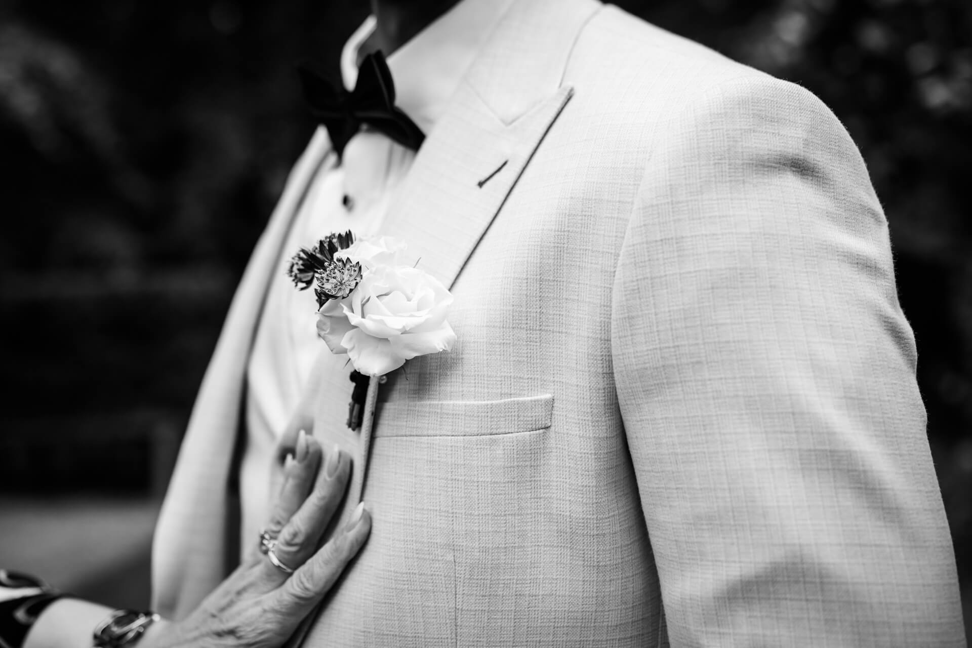 Close-up of boutonnière on suit jacket