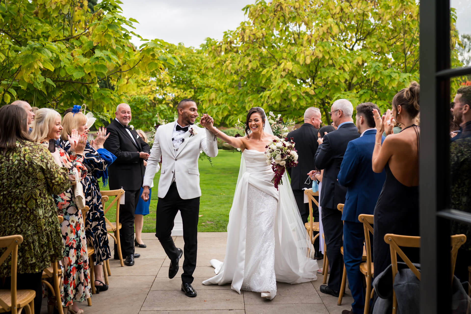 Wedding couple triumphantly walking down the aisle.