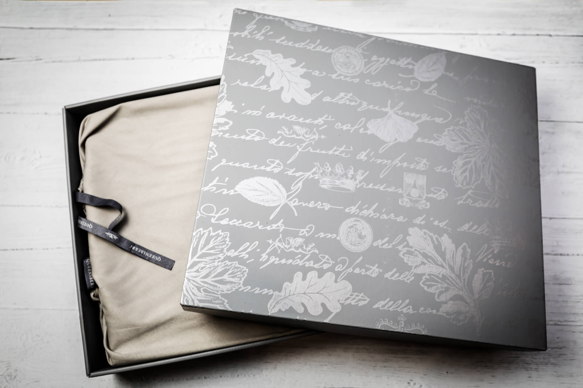 Elegant gift box with decorative patterns and ribbons.