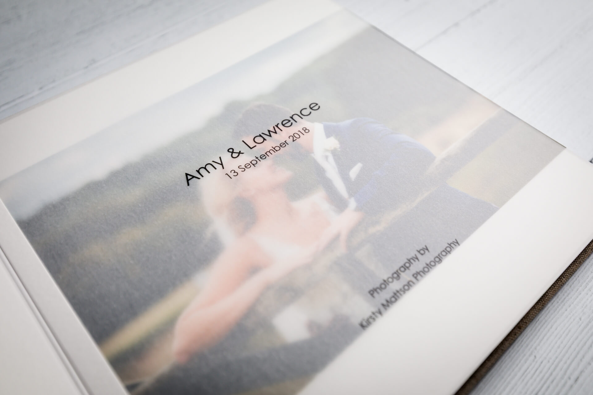 Wedding album cover with couple's names and date.