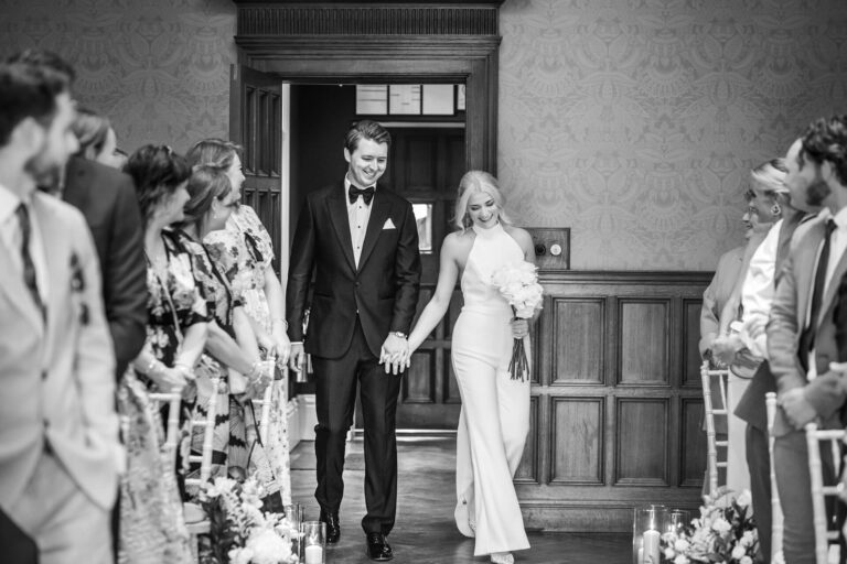 Bride and groom enter wedding ceremony together.