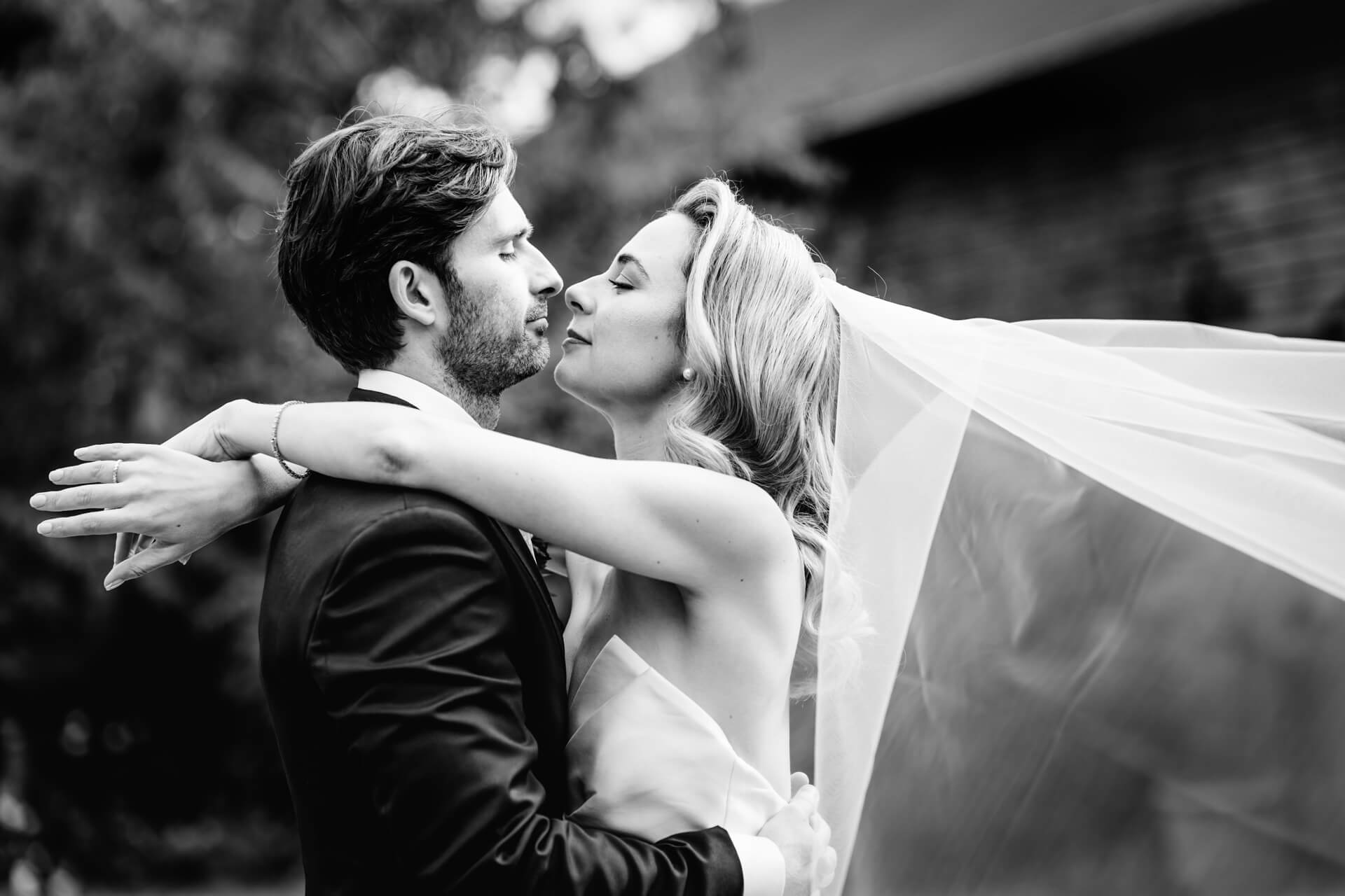 Bride and groom embracing on wedding day.