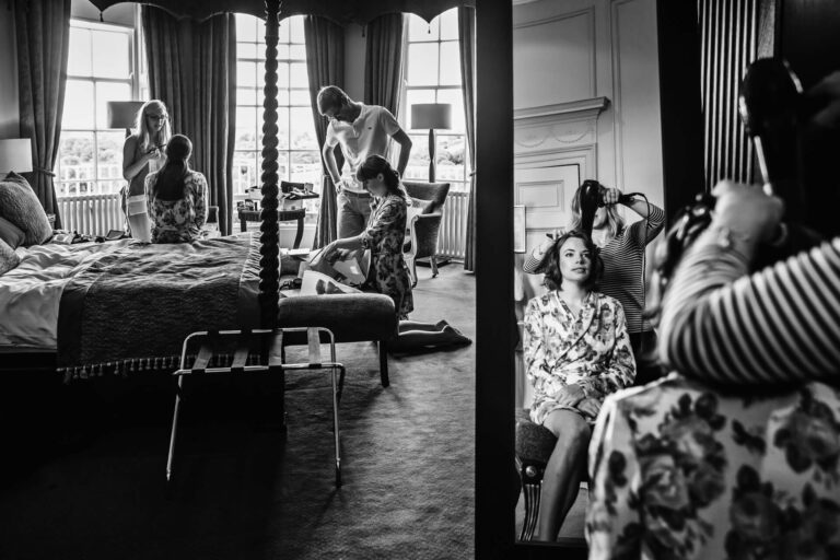 Bridal party getting ready in elegant hotel room.