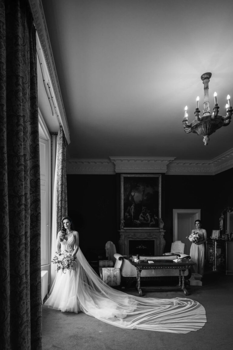 Bride in elegant room with long flowing gown.