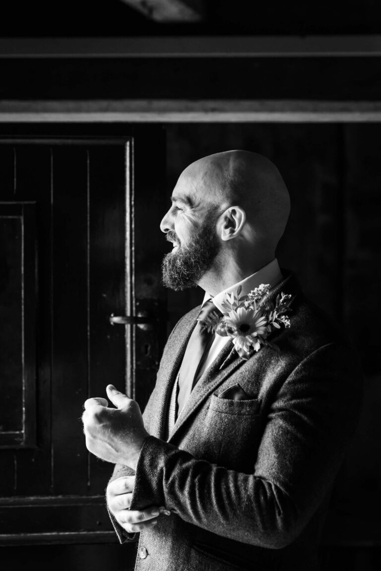 Smiling man in suit with flower boutonniere