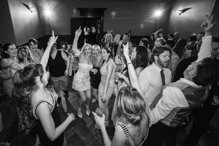 People dancing energetically at a party celebration.