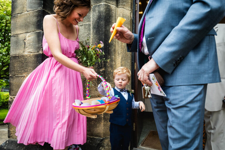 Woman and child with basket at wedding ceremony.