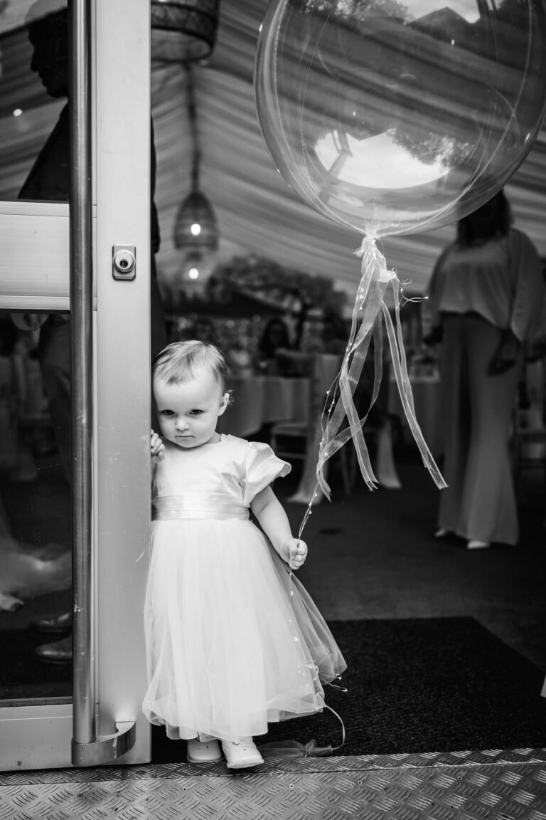 Child holding balloon at outdoor event