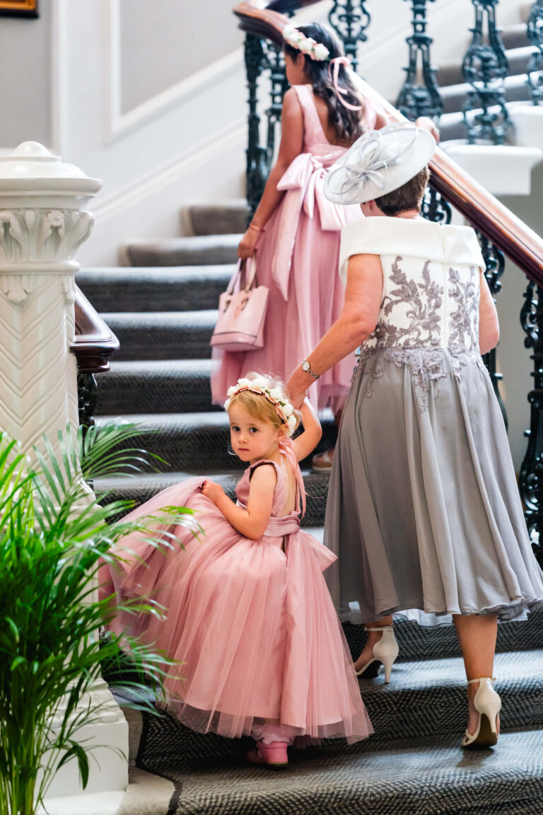Elegant family ascending staircase at event.