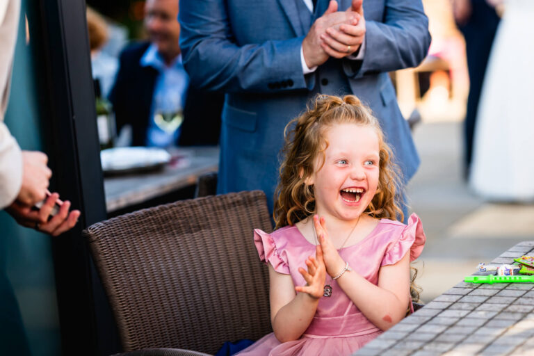 Smiling girl clapping at party outdoors