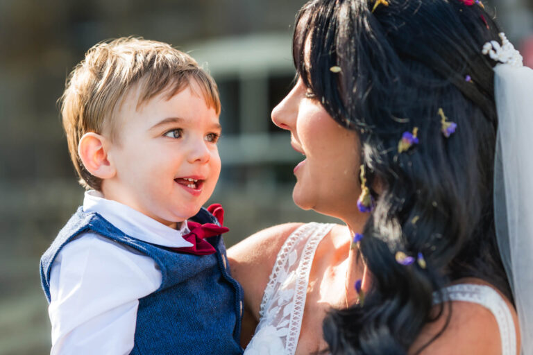 Smiling child and woman celebrating outdoors.