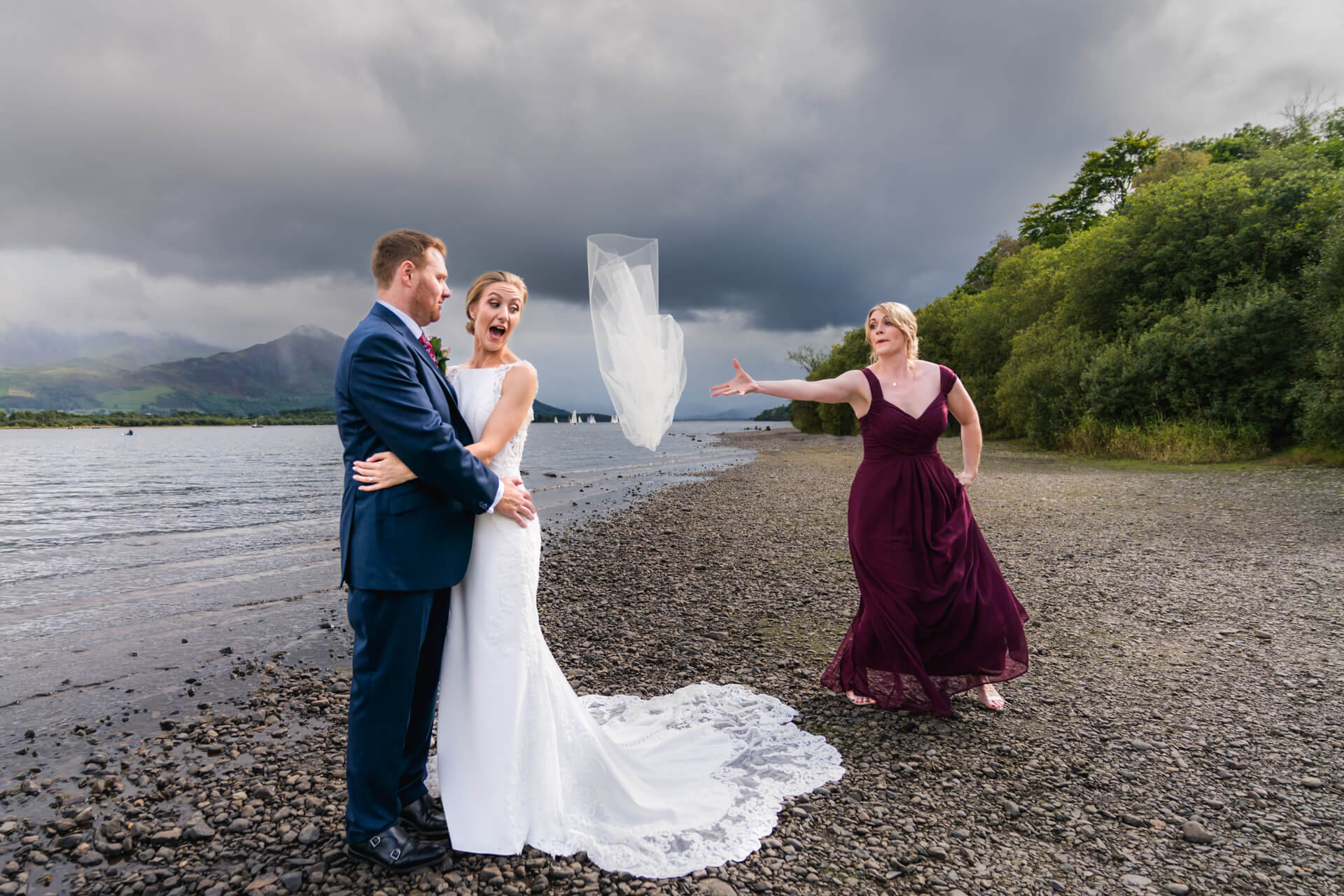 Bride’s veil blowing away on windy lakeshore wedding